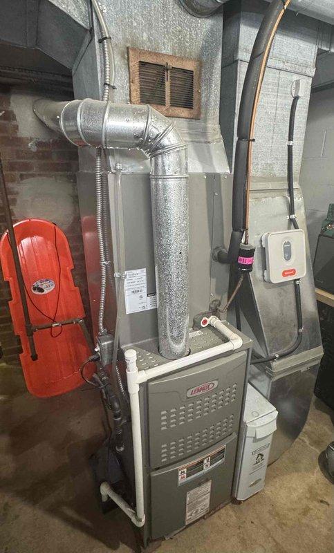 Completed seasonal tune-up service on two Lennox furnace systems located in basement utility area. Both units were inspected and serviced according to manufacturer specifications, including examination of ductwork connections, condensate drain lines, and ventilation systems. Confirmed proper operation of both heating systems with normal airflow and no safety concerns identified.