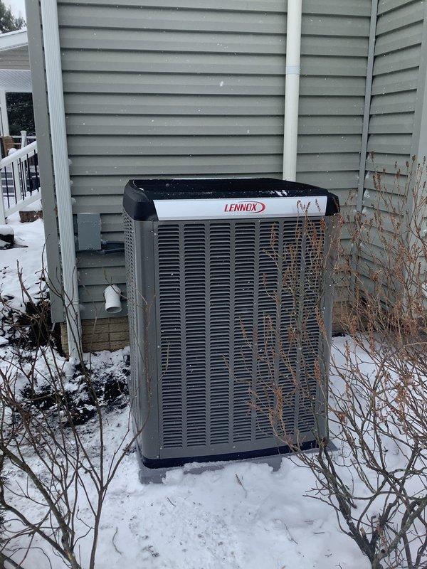 Completed installation of Lennox outdoor condensing unit as scheduled follow-up service. Unit was properly positioned on exterior wall adjacent to utility room housing the previously installed air handler. System was tested and verified operational with all connections properly sealed and insulated. Installation completed despite winter conditions.