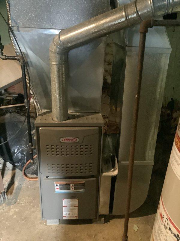 Diagnosed and repaired pilot light issue on 9-year-old Lennox furnace that was failing to remain lit. Inspected ventilation system including circular intake grille and main ductwork, confirming proper airflow after service completion.
