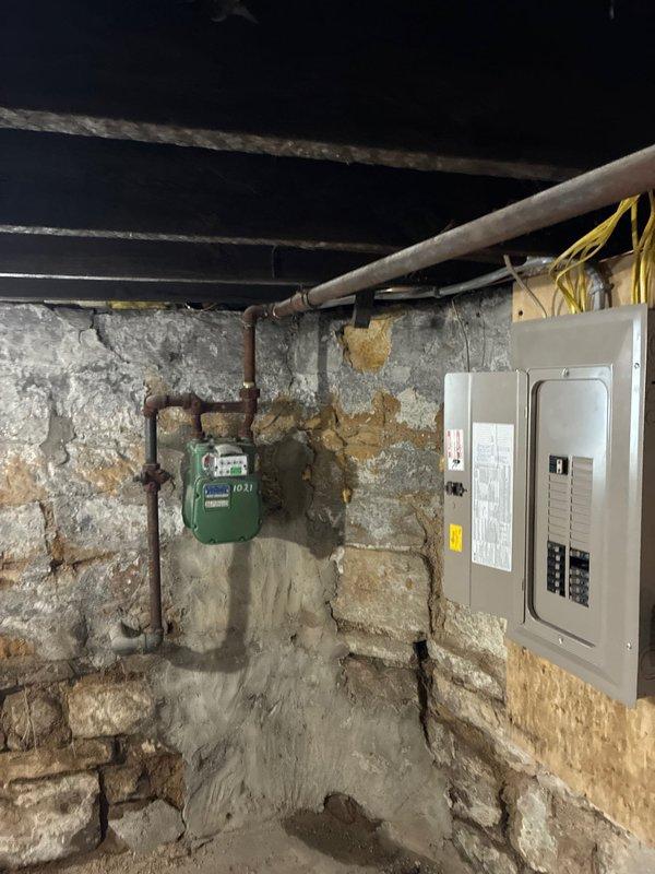 Conducted electrical inspection of property to identify code compliance issues. Found outdated electrical panel in basement with improper wiring connections, and significant wall damage exposing deteriorated structural elements that require remediation. Documented all electrical deficiencies for comprehensive estimate to bring property up to current electrical code standards.