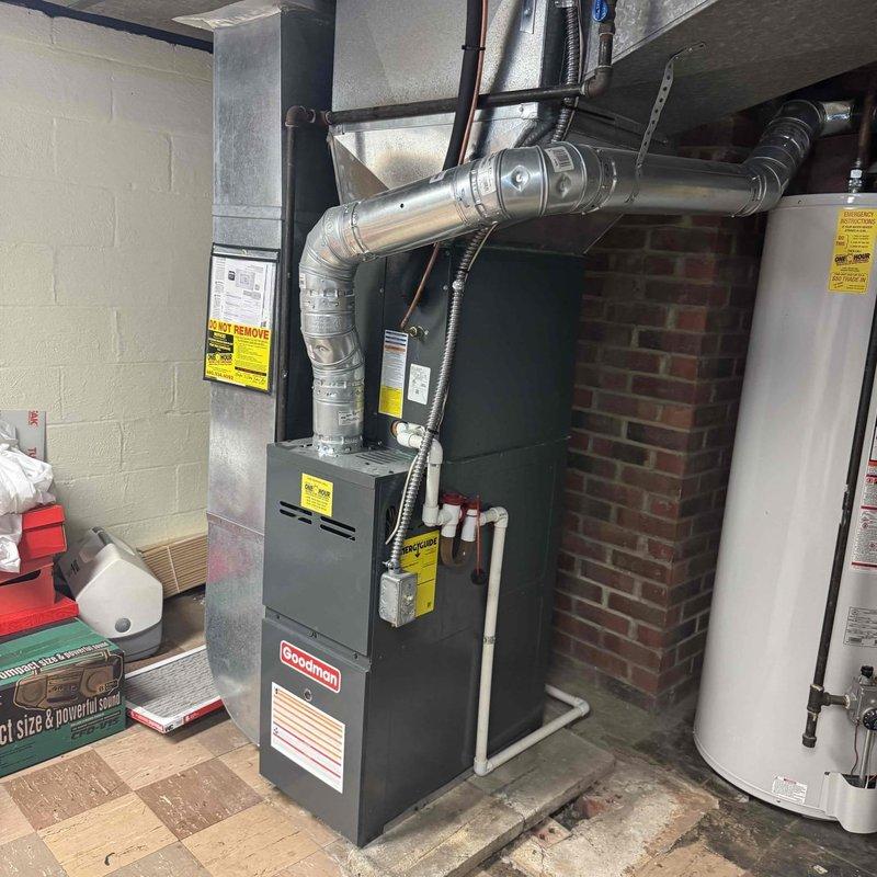 Performed comprehensive tune-up maintenance on 30-year-old Goodman furnace located in basement utility room. Inspected blower motor assembly, electrical connections, and gas valve assembly for proper operation. System shows significant age but is functioning within acceptable parameters after service.