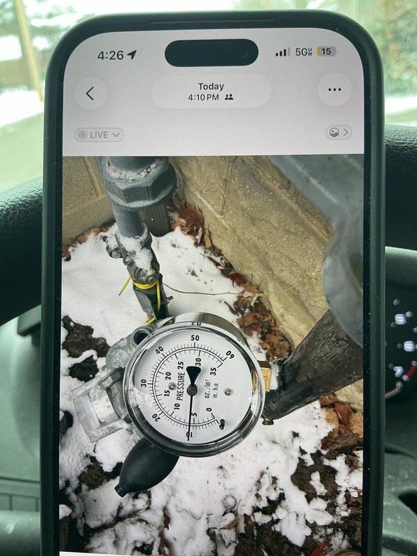 Responded to a reported gas leak. Performed pressure test on gas lines with gauge showing reading between 5-10 PSI. Enbridge technician confirmed leak was still present after initial inspection. Documented system conditions with photos showing frost accumulation on pipes and fittings.