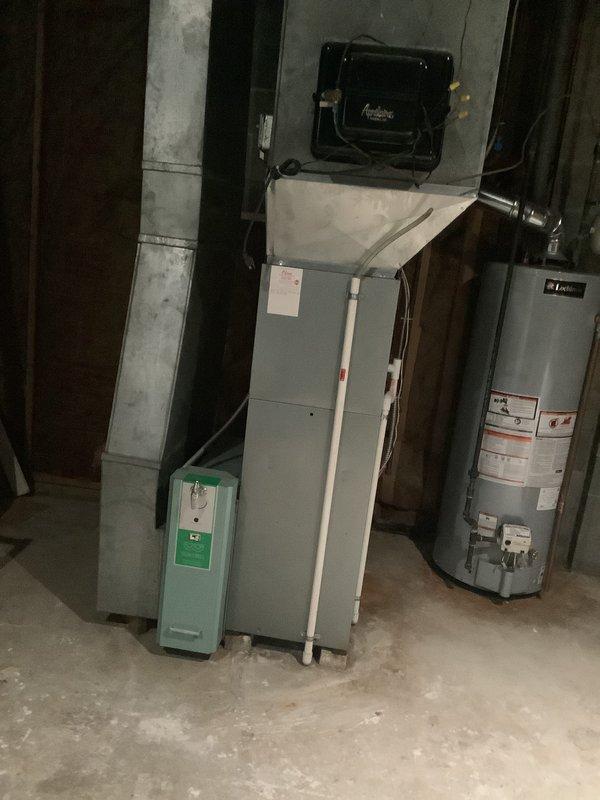 Conducted comprehensive assessment of existing HVAC system for pre-sale home evaluation. Documented aging furnace unit with connected PVC venting, adjacent water heater, and auxiliary air quality equipment. Inspection revealed copper piping infrastructure and ductwork requiring attention, with particular focus on the evaporator coil housing and ventilation connections. Recommended complete system replacement to address age-related concerns and improve home marketability.