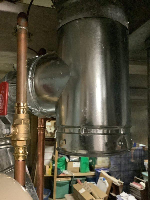 Replaced deteriorated B-vent under warranty in utility area. Installed new galvanized metal ventilation pipe with proper connection joints and fasteners. Inspected and verified all connections are secure with appropriate sealing material at the circular joint elbow section.