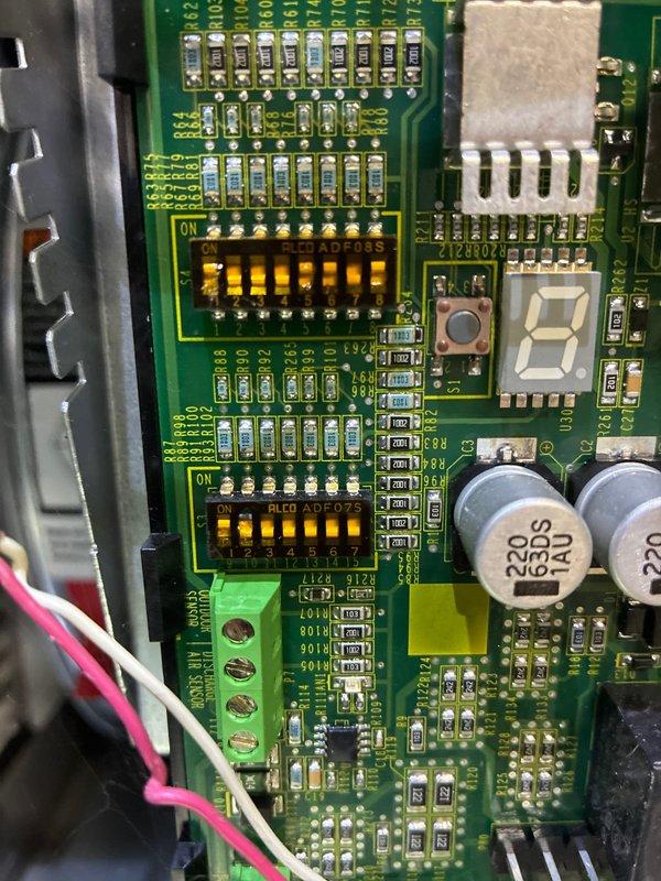 Performed routine MVP furnace maintenance including inspection of the control board and circuit components. Examined the PCB containing DIP switches, capacitors, and terminal connections for proper functionality. Used hex tool to make necessary adjustments to system components and verified proper operation of the electronic control system.