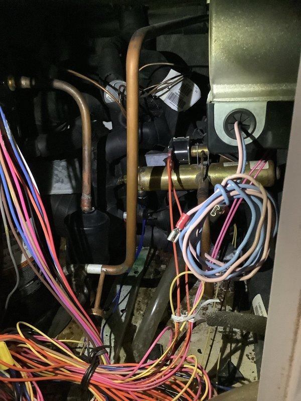 Performed routine maintenance on 20-year-old geothermal system, inspecting internal electrical components including blower assembly, fuses, and control board. Checked copper tubing, valves, and insulation on refrigerant lines, and verified all electrical connections were secure with no signs of deterioration.