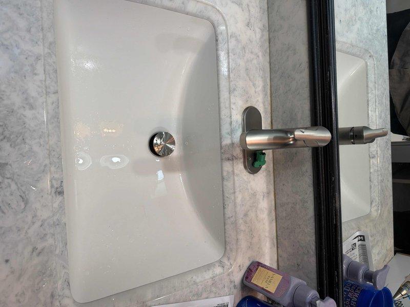 Completed installation of customer-supplied lavatory faucet in master bathroom with new supply lines connected to existing valves. Successfully replaced waste and overflow assembly in second floor hall bathtub after pumping out standing water, and cleared drain to ensure proper drainage functionality.