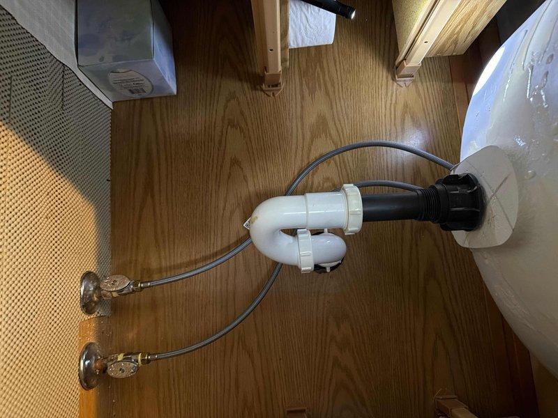 Completed installation of customer-supplied lavatory faucet in master bathroom with new supply lines connected to existing valves. Successfully replaced waste and overflow assembly in second floor hall bathtub after pumping out standing water, and cleared drain to ensure proper drainage functionality.