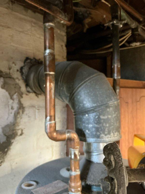 Completed assessment of 17-year-old furnace and hot water tank for potential replacement. Inspection revealed aging copper pipes with deteriorated sealing material, galvanized steel ductwork with significant dust accumulation, and signs of water damage on surrounding concrete walls. Recommended replacement with new MVP system based on observed wear and deterioration of existing components.