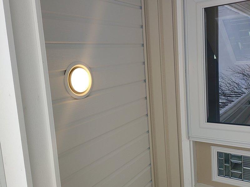 Diagnosed exterior light fixture issues reported by customer. Located faulty wiring connections at interior light switch that controlled outdoor fixtures. Repaired connections and verified proper operation of exterior circular wall-mounted light fixture.