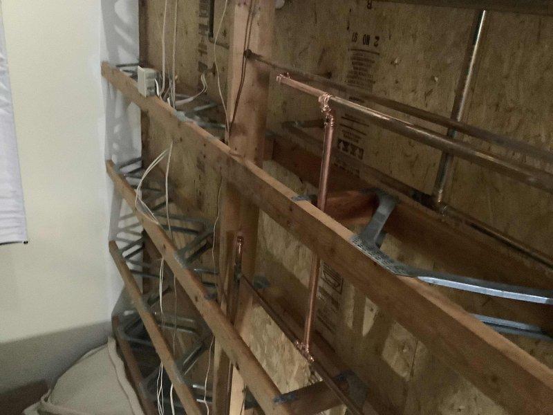 Completed re-plumbing of the kitchen and upstairs hot water loop to address low flow issues, installing a new manifold system with purge valves and isolation valves for improved sectional control. Replaced water-logged expansion tank with a new 2.1 gallon unit, ensuring proper system pressure regulation and enhanced hot water distribution throughout the property.