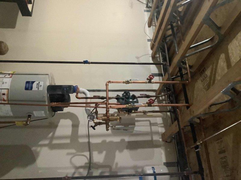 Completed re-plumbing of the kitchen and upstairs hot water loop to address low flow issues, installing a new manifold system with purge valves and isolation valves for improved sectional control. Replaced water-logged expansion tank with a new 2.1 gallon unit, ensuring proper system pressure regulation and enhanced hot water distribution throughout the property.