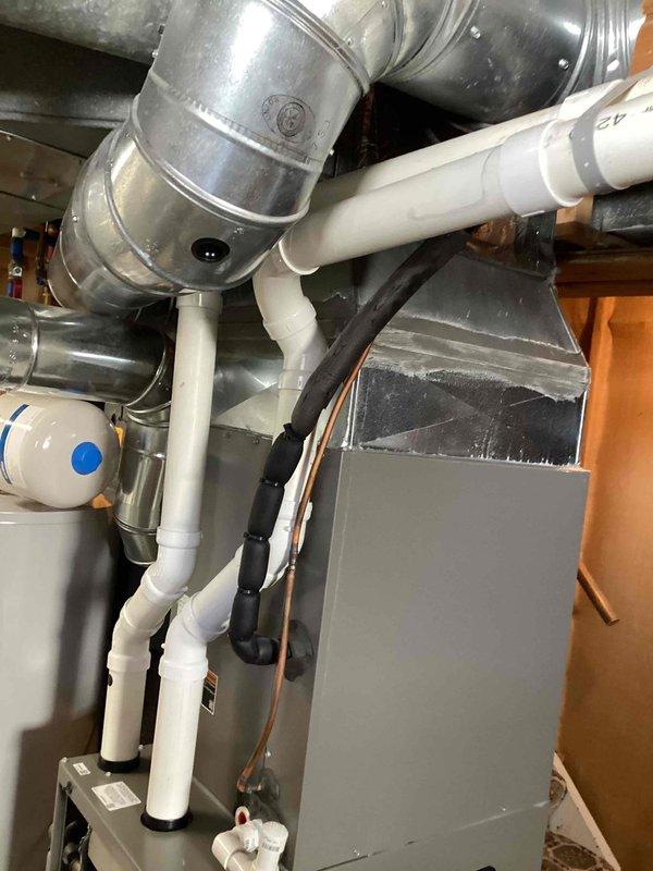 Performed routine maintenance on furnace unit, inspecting internal components and wiring. Checked condensate drain line and PVC drainage system for proper function. Verified connections between furnace and water heater were in good working condition with no visible leaks or damage to ductwork or plumbing fixtures.