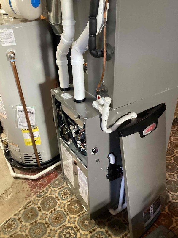 Performed routine maintenance on furnace unit, inspecting internal components and wiring. Checked condensate drain line and PVC drainage system for proper function. Verified connections between furnace and water heater were in good working condition with no visible leaks or damage to ductwork or plumbing fixtures.