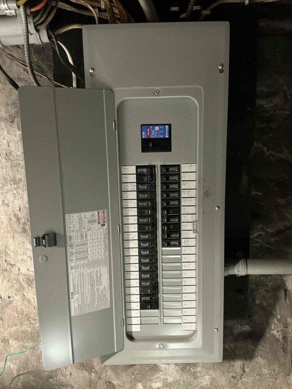 Conducted generator site assessment, evaluating existing electrical panel configuration for proper integration. Documented main service panel with digital display and dual vertical breaker columns for load calculation purposes. Client informed of propane requirement for selected generator system.
