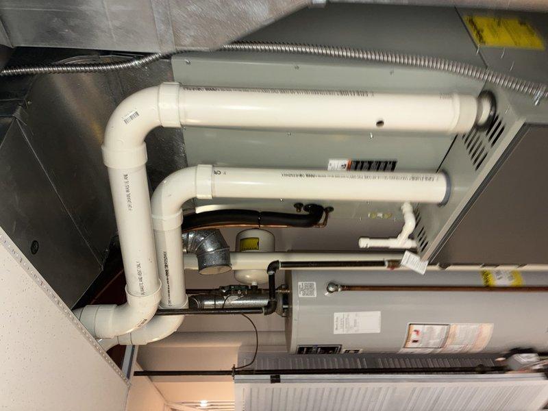 Performed routine AC tune-up on 9-year-old Carrier system. Inspected and verified proper operation of the furnace and humidifier unit. System is functioning correctly with no issues detected; all components including PVC venting system and connections are in good working condition.