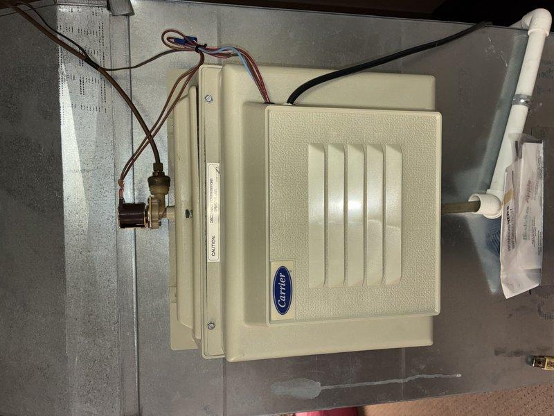 Performed routine AC tune-up on 9-year-old Carrier system. Inspected and verified proper operation of the furnace and humidifier unit. System is functioning correctly with no issues detected; all components including PVC venting system and connections are in good working condition.