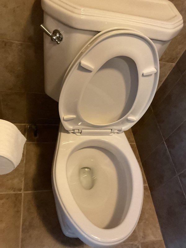 Responded to service call for dual plumbing issues: leaking toilet at base and loose faucet handle in secondary bathroom. Diagnosed toilet seal failure causing water seepage onto floor tiles. Repaired bathroom sink faucet by tightening loose handle assembly and checking for proper operation. Both fixtures were restored to proper working condition with no further leaks observed.