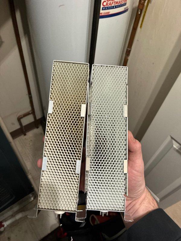 Replaced severely soiled UV/Air scrubber bulb in customer's HVAC system to restore proper air purification functionality. Documented condition of old filters showing significant dust accumulation and discoloration compared to new components. Installation completed and system returned to normal operation.