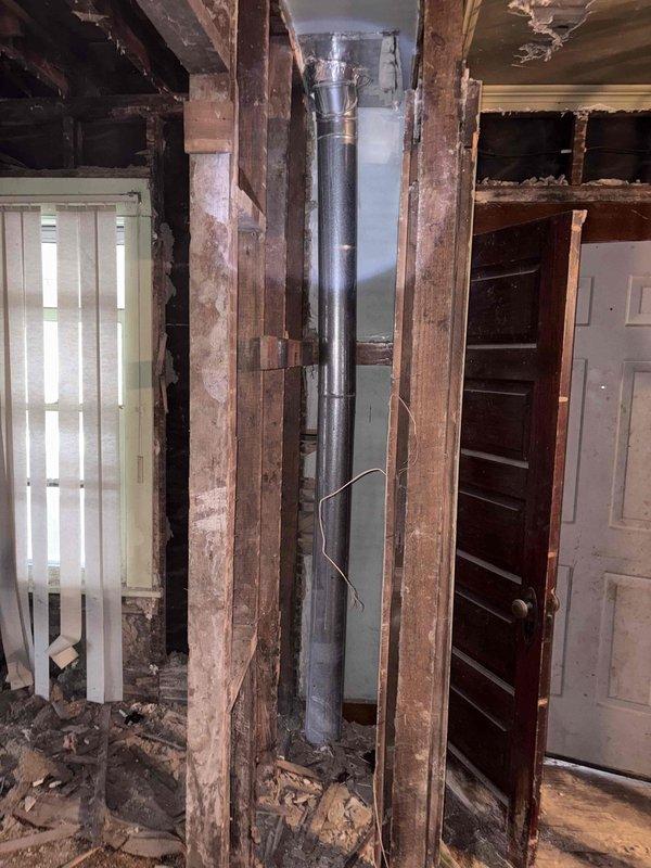 Completed full HVAC system replacement including furnace, AC, ductwork, and tankless water heater installation. Work involved significant demolition of existing infrastructure with removal of damaged ceiling materials and wall sections to accommodate new ductwork routing. System installation required structural integration with existing framework in a property undergoing extensive renovation.