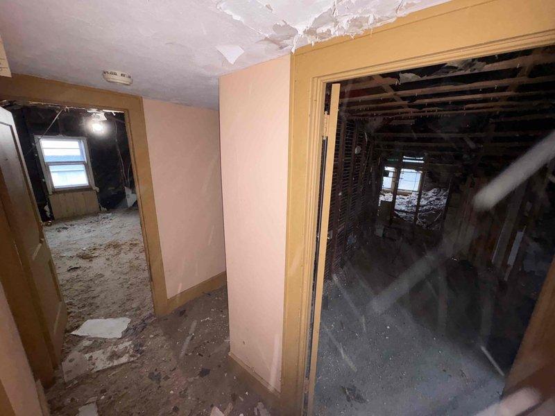 Completed full HVAC system replacement including furnace, AC, ductwork, and tankless water heater installation. Work involved significant demolition of existing infrastructure with removal of damaged ceiling materials and wall sections to accommodate new ductwork routing. System installation required structural integration with existing framework in a property undergoing extensive renovation.