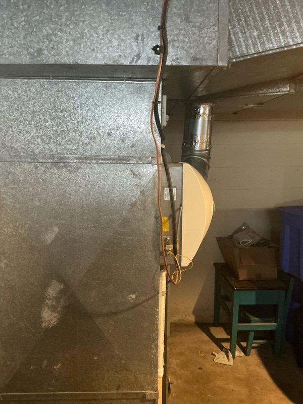 Conducted a furnace replacement estimate on a 13-year-old system. Inspected existing HVAC setup including metal ductwork, PVC venting/drainage, and connection points. Photographed current installation to document system configuration and space constraints for proper replacement unit sizing.