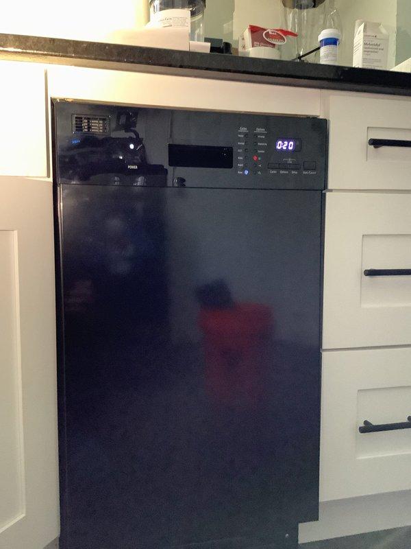 Completed customer-supplied dishwasher installation in kitchen with white cabinetry. Properly connected water supply, secured unit within cabinet space, and verified functional operation. Final installation included proper alignment with surrounding cabinetry and operational testing of control panel.