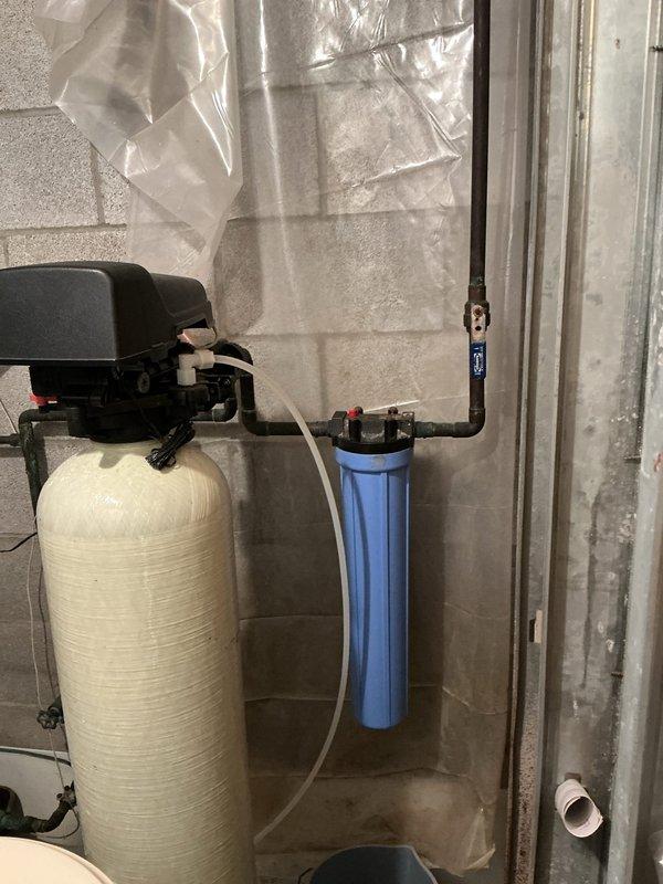 Performed diagnostic assessment on Pentair 4601 water softener system experiencing pressure loss issues. Identified mineral buildup in control valve and blue filter housing restricting flow. Disassembled system, cleaned internal components, replaced filter media, and restored proper water pressure while maintaining system functionality.