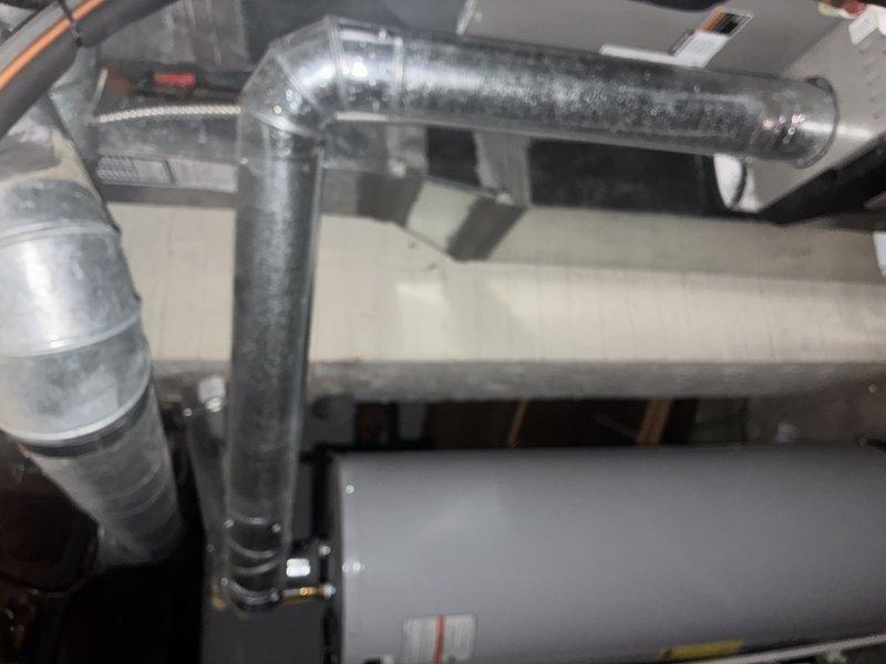 Performed scheduled MVP furnace maintenance service. Inspected ductwork system including galvanized metal T-connections and main trunk lines for proper sealing and structural integrity. Utilized specialized L-shaped tool for accessing and examining furnace components. All connections verified secure with no visible air leaks detected.