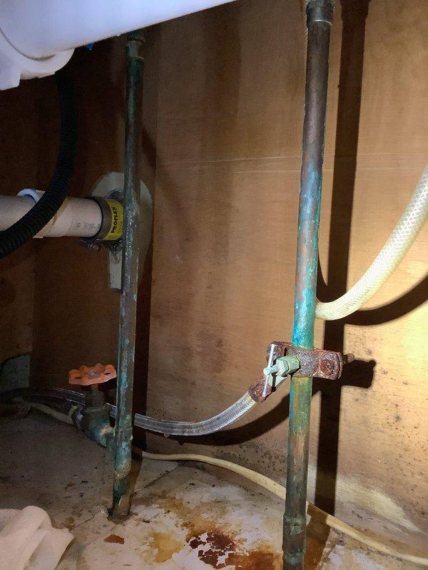 Responded to kitchen sink leak complaint and identified significant corrosion on copper supply lines with visible water damage to surrounding wood surfaces. Removed deteriorated plumbing components and successfully installed customer-provided Moen Adler model 87702 faucet, ensuring proper connections and testing for leaks before completion.