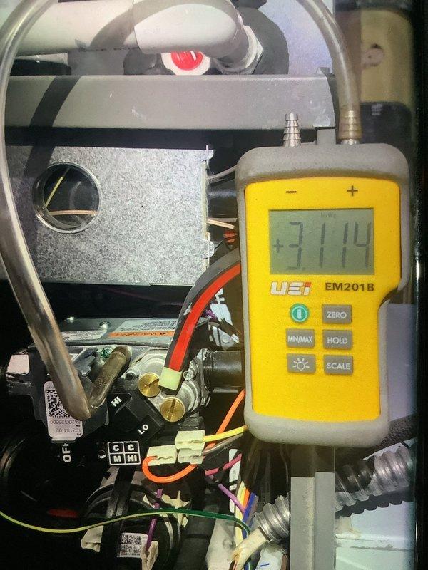 Performed scheduled maintenance on 4-year-old heating system. Conducted static pressure measurements (reading 3114) using UEi EM201B meter on internal components. Inspected and noted moderate dust accumulation on pleated air filter, which remains functional and does not require immediate replacement.