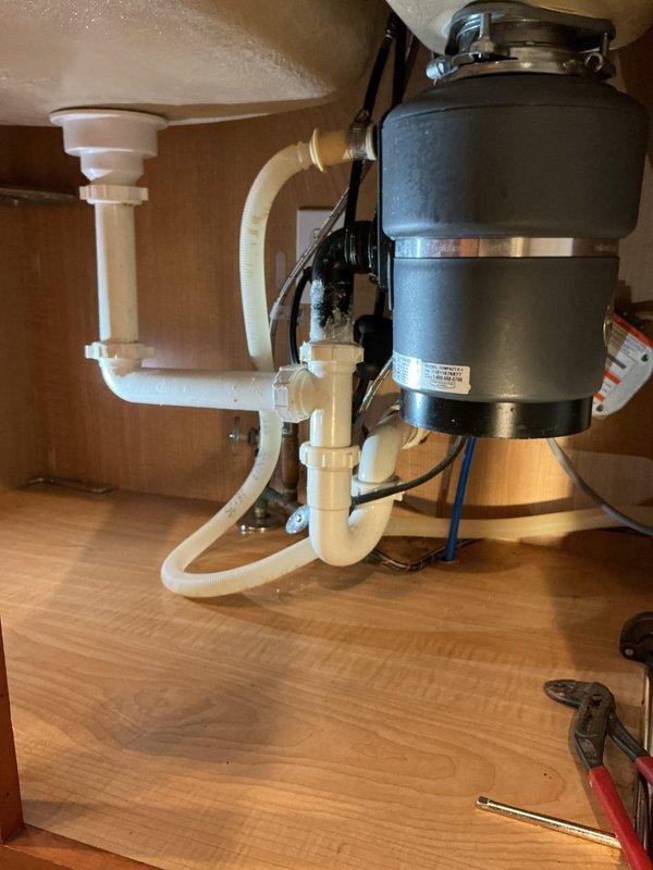 Successfully installed customer-supplied kitchen faucet, replacing existing unit with new modern stainless steel model featuring pull-down sprayer functionality. Properly connected all supply lines and verified operation of both main faucet and secondary filtered water dispenser, ensuring no leaks at connection points.