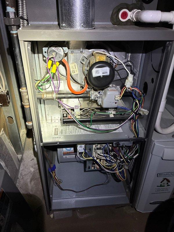 Performed comprehensive heating system maintenance on a forced-air furnace. Inspected interior components including motor assembly, electrical connections, and control board circuitry. All wiring connections were verified secure with no signs of wear or damage, and system was confirmed to be functioning within normal operating parameters.