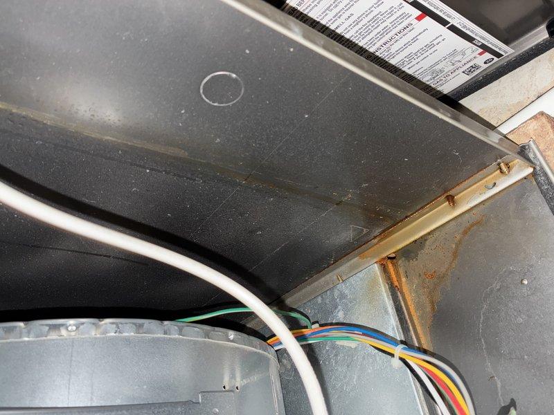 Performed MVP furnace maintenance and found condensate drainage issue causing water pooling on one side of unit. Inspected interior components revealing dusty conditions, minor corrosion on metal seams, and verified electrical connections to motor assembly. Checked ductwork which showed proper installation with normal wear; moisture observed in ventilation system consistent with reported water issue.