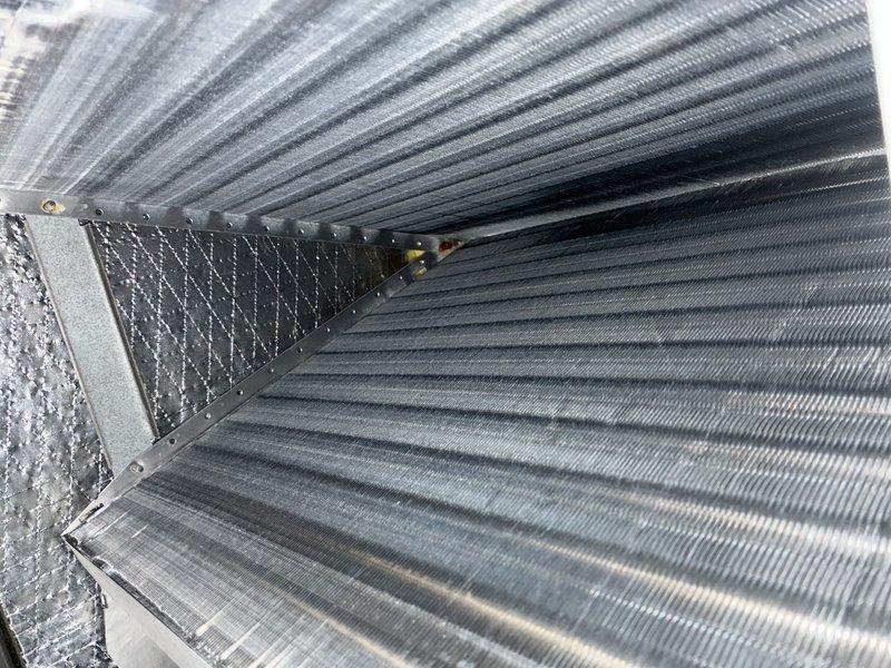 Performed MVP furnace maintenance and found condensate drainage issue causing water pooling on one side of unit. Inspected interior components revealing dusty conditions, minor corrosion on metal seams, and verified electrical connections to motor assembly. Checked ductwork which showed proper installation with normal wear; moisture observed in ventilation system consistent with reported water issue.
