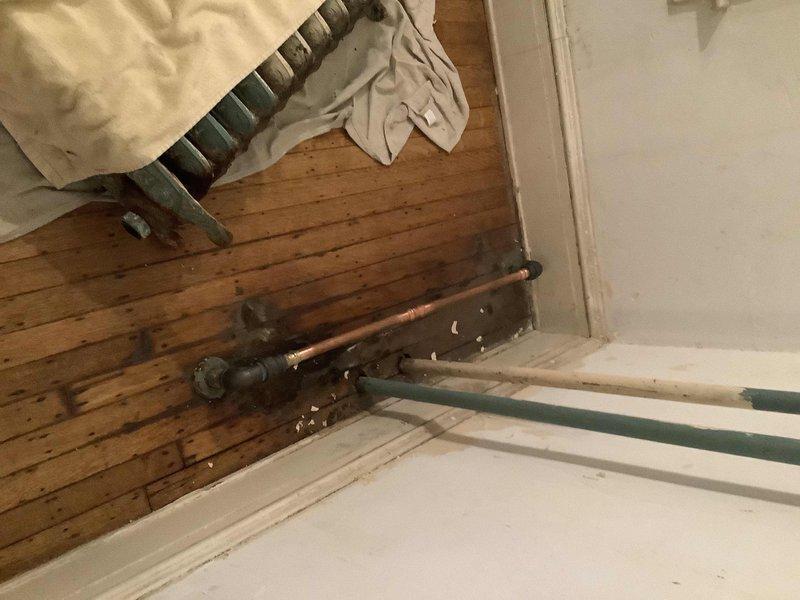 Completed installation of customer-supplied radiator on first floor with new radiator valve and modified piping to accommodate the smaller unit dimensions. Replaced coin vent in first floor bathroom and restored heating system to full operation. Job involved copper pipe work and connection fittings as documented in service photos.