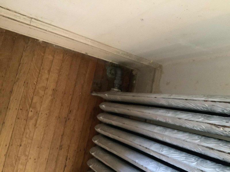 Completed installation of customer-supplied radiator on first floor with new radiator valve and modified piping to accommodate the smaller unit dimensions. Replaced coin vent in first floor bathroom and restored heating system to full operation. Job involved copper pipe work and connection fittings as documented in service photos.