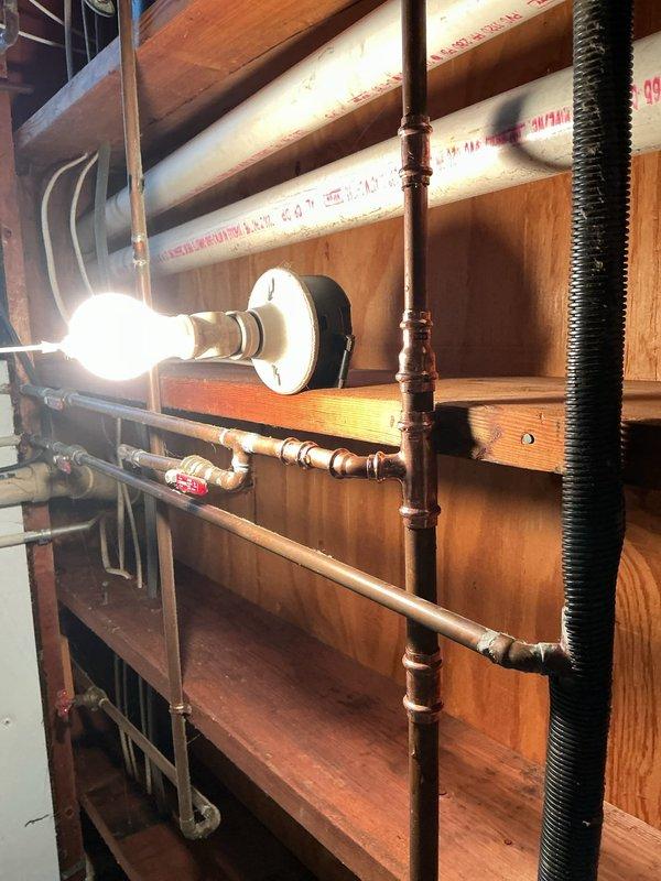 Responded to service call for water leak in basement. Performed diagnostic inspection of the exposed copper pipe system running along wooden joists and identified source of leak. Repaired compromised pipe section and tested system to ensure proper function with no further leakage.