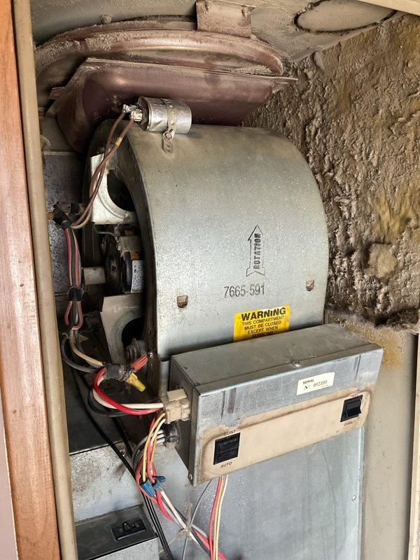 Diagnosed furnace ignition failure in a mobile home heating system (unit #50). Inspection revealed a failed capacitor preventing proper blower motor operation, which inhibited flame ignition sequence. Replaced defective capacitor and verified complete ignition cycle, restoring normal heat function. System now operating within manufacturer specifications.