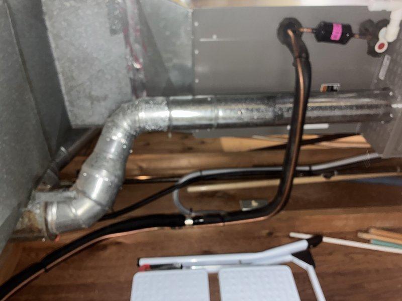 Completed routine maintenance on MVP furnace system. Inspected all components including heat exchanger, burners, blower assembly, and refrigerant lines. System appears to be properly installed on wooden supports with appropriate ductwork connections and is functioning within normal parameters.