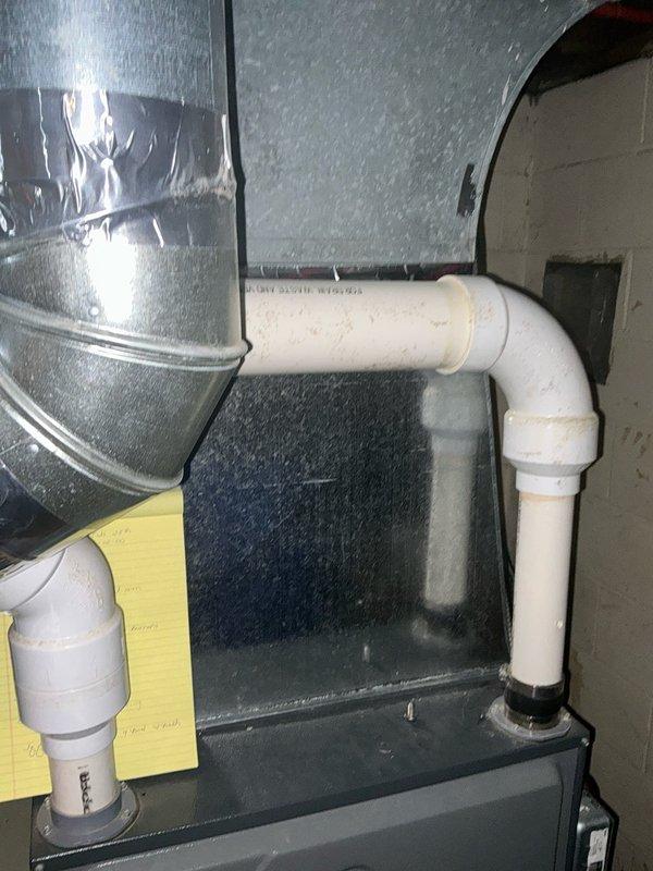 Completed installation of a 90k BTU furnace system with proper ductwork connections and sealed joints using metal tape. Installed PVC venting with appropriate horizontal and vertical runs, secured to joists with plastic straps according to manufacturer specifications.