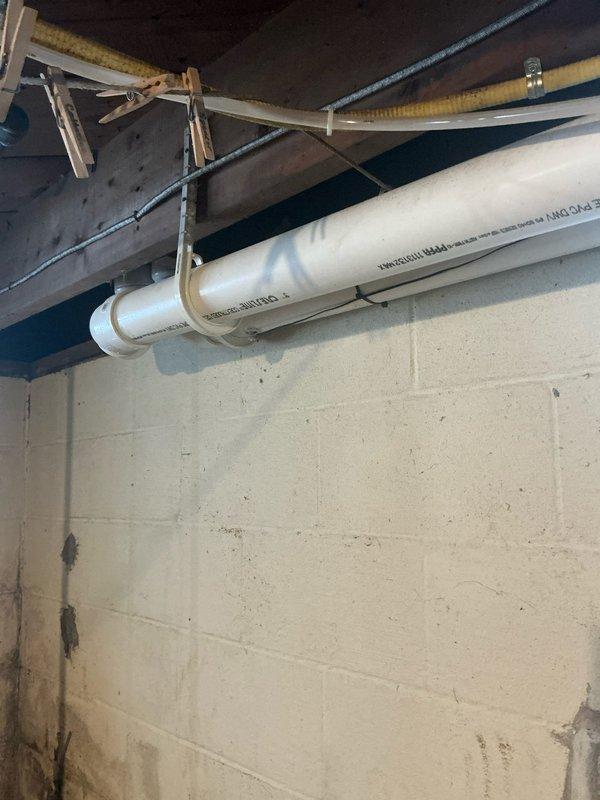 Completed installation of a 90k BTU furnace system with proper ductwork connections and sealed joints using metal tape. Installed PVC venting with appropriate horizontal and vertical runs, secured to joists with plastic straps according to manufacturer specifications.
