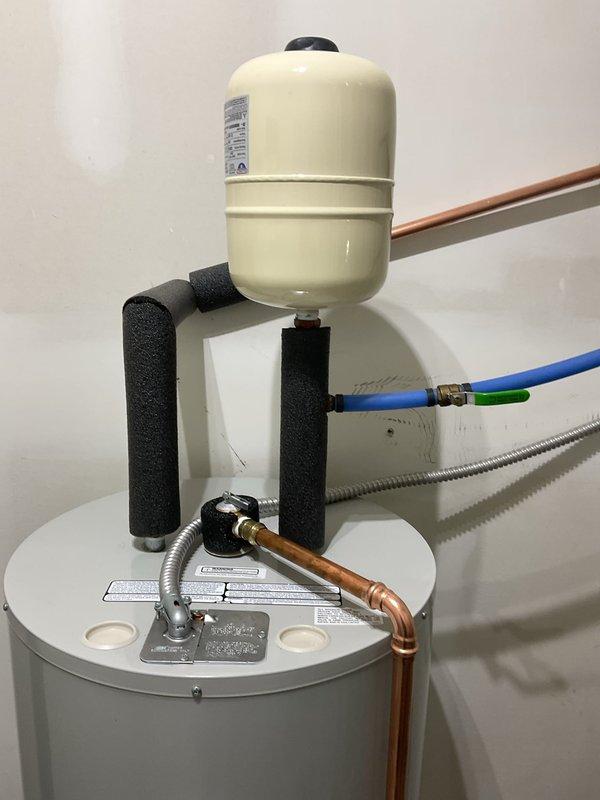 Successfully replaced 40-gallon electric water heater with new Rheem Classic Professional model. Installed expansion tank with proper copper piping connections and ensured all water supply/drainage connections were secure. System is functioning properly with all required safety components in place.