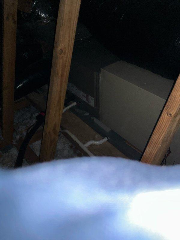 Conducted an HVAC replacement estimate for an aging furnace system located in the attic space. Inspected existing installation configuration including ductwork, electrical connections, and condensate drainage, noting the current setup features a water sensor integrated with the contactor coil. System replacement would require proper adaptation to existing framework while ensuring adequate clearance and proper connection to current distribution system.