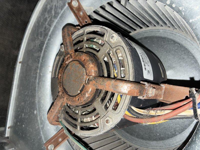 Performed scheduled MVP Heating maintenance service. Inspected heat exchanger which showed dust accumulation between fins requiring cleaning. Noted significant rust formation on motor mounting bracket while motor itself remains operational with proper electrical connections intact. System restored to proper working condition.
