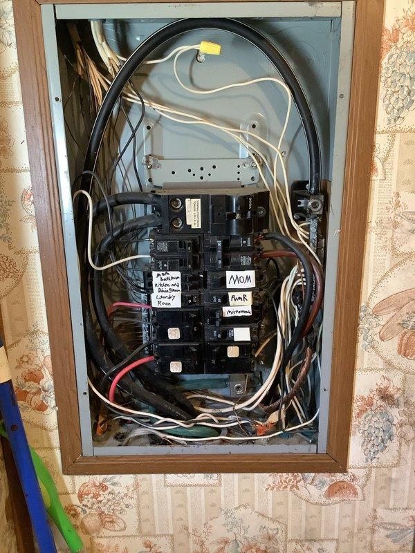 Inspected customer's electrical panel to assess power loss in three rooms. Evaluated both interior and exterior breaker boxes, documenting the current installation with photos. Panel shows significant age with disorganized wiring and handwritten labels. Recommended replacement of breaker panel to resolve ongoing electrical issues.
