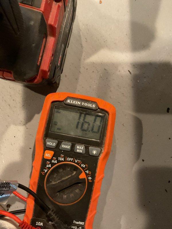 Performed scheduled furnace tune-up service which was previously rescheduled. During inspection, identified a structural crack in the heat exchanger and verified with electrical testing using multimeter, reading 16.0V. Documentation photos taken of damaged component for service records.