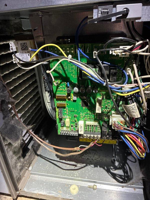 Performed scheduled furnace tune-up service on Lennox system. Inspected blower motor assembly, fan wheel, and electrical connections. Examined control board components and verified proper operation of gas valve assembly with all wiring connections secure and functional.