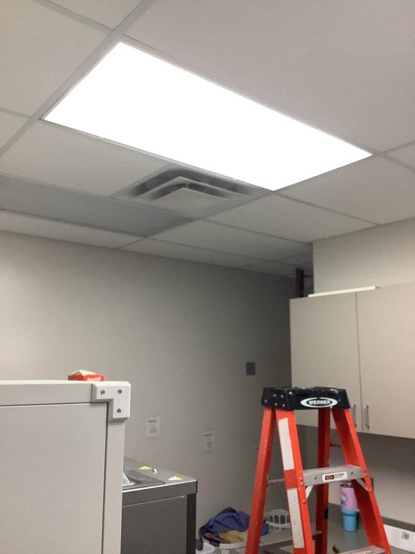 Completed bypass of ballasts on 10 light fixtures and replaced the ballast in the front foyer light fixture. Work involved accessing ceiling-mounted fixtures using ladder in commercial space with drop ceiling tiles and pendant lighting. Parts were received and installation was completed as scheduled.