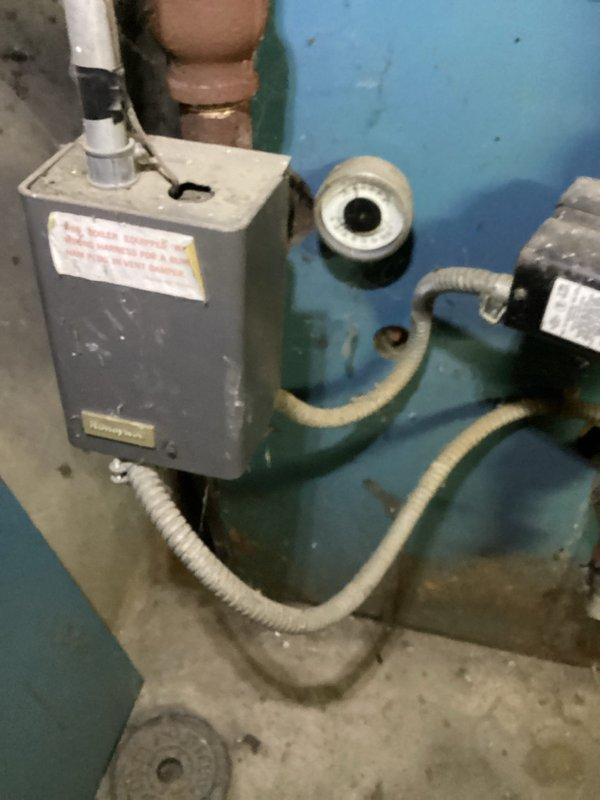 Performed routine tune-up on aging blue boiler system located in basement. Inspected Honeywell control unit, heat exchanger fins, and flue connections for proper operation. Cleaned components, verified proper combustion, and confirmed system safety controls were functioning correctly.
